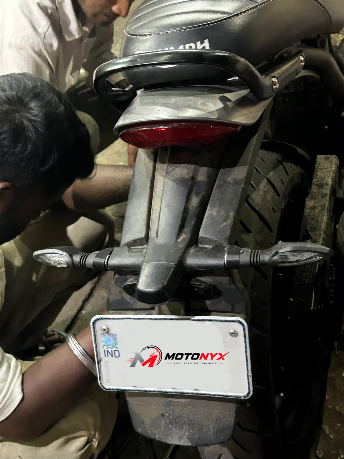 Rear of a Triumph 400 with MotoNyx indicators and numberplate keyring being fitted